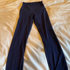 Navy Blue Lululemon Leggings with the name Lululemon down the leg